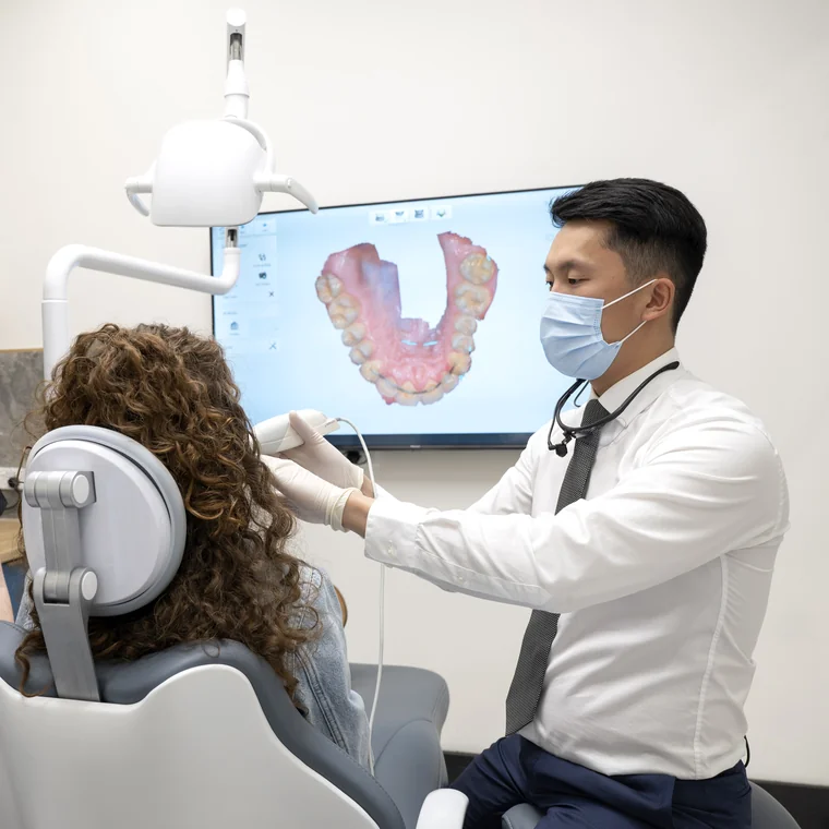 Dr Shaun Goh using an intraoral scanner to capture a patient's digital dental scan