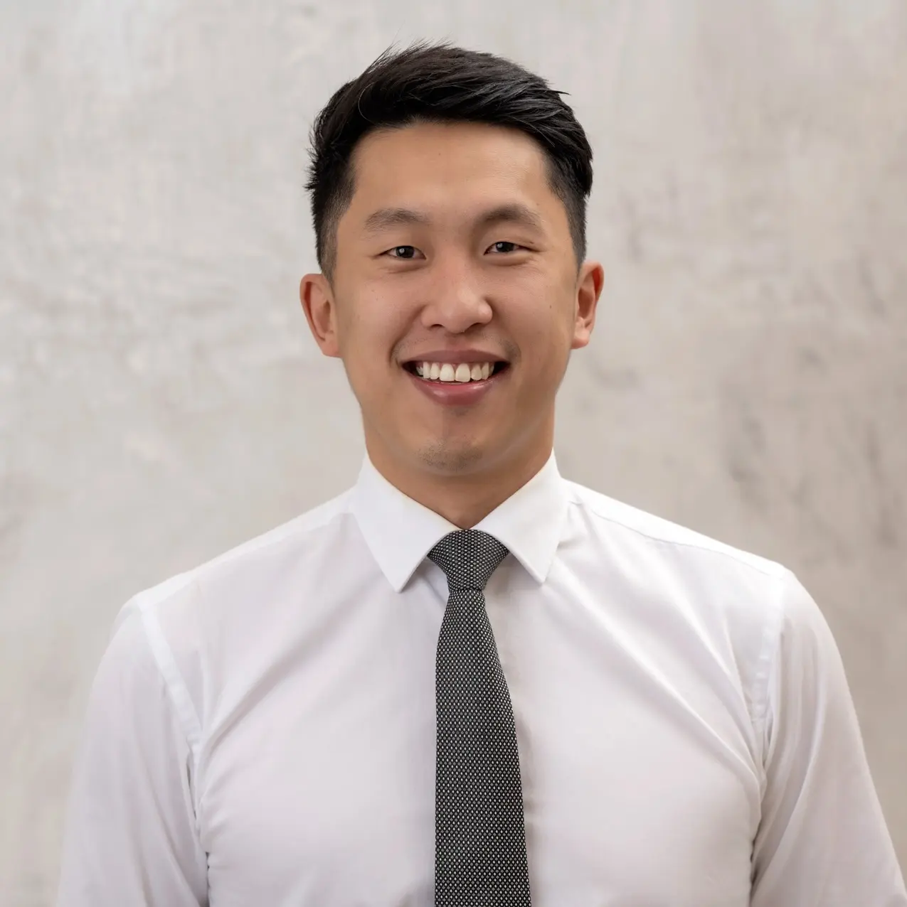 Dr Shaun Goh holding a clear aligner in a Go Orthodontics clinic